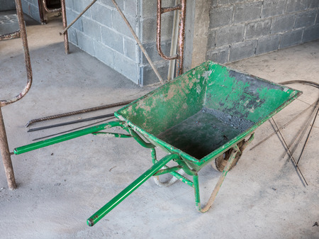 Old green trolley for contain the cement brick to built in the unfinished house.の写真素材