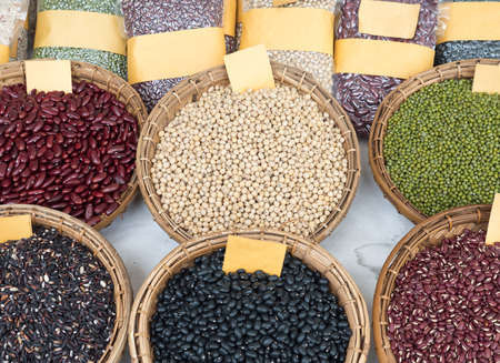 Variety of the organic whole grains in the wooden basket,local market in the countryside of...
