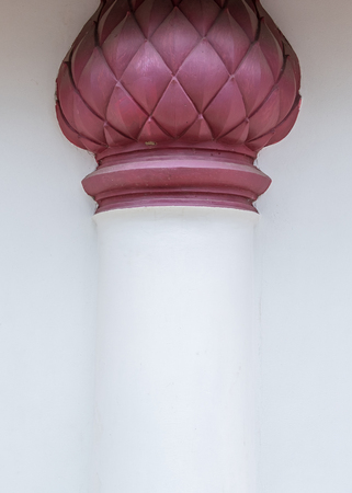 White pillar with the red lotus stucco on the wall for decoration around the Thail church.