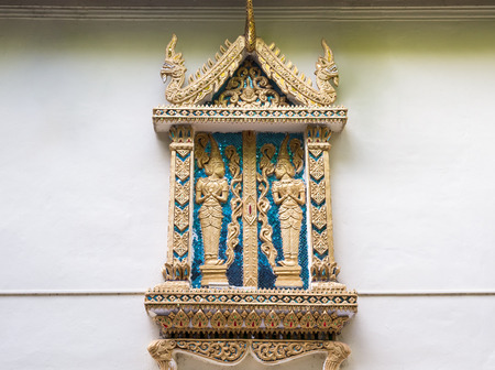 Golden angel stucco in the traditional Thai style for decoration  on the church wall,northern of Thailandの写真素材