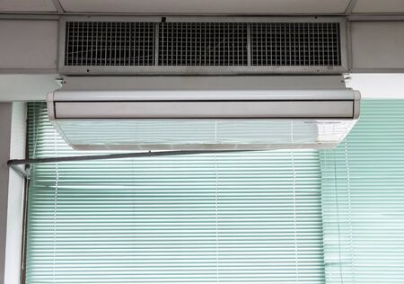 New air conditioner unit is hanging on the ceiling which near the old air conditioner system  of the...