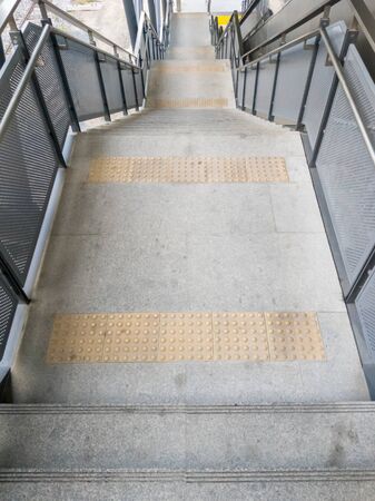 Modern staircase with the metal handrail of the metro sky train for go down to the street.Bangkok...