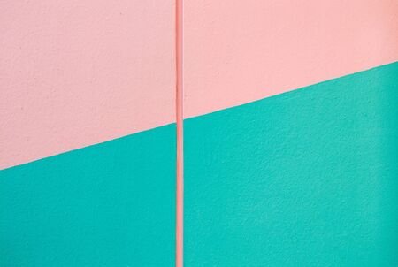 The wall painted with two pastel color old rose and soft green on the house wall.の写真素材