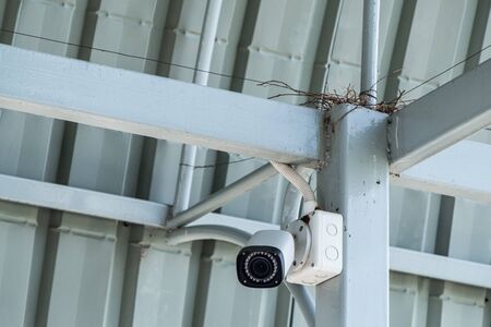 Cctv security camera for inspection around the large warehouse in the industrial park.