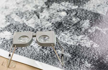 Pocket stereoscope near the aerial photograph for interpretation the land use of the countryside area, photogrammetry technologyの写真素材
