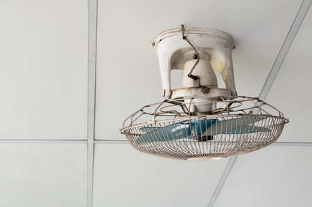 The old orbit fan with the many stains and dust is hanging on the ceiling of the relax area in the...