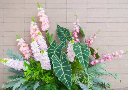 Artificial flowers from the fabric and plastic tree near the entrance to the meeting room for...