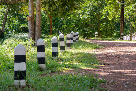 The lonely pathway from the start point to the long-distance nature trail in the national park, small pillar along the way to protect the traveler, selective focus.の写真素材