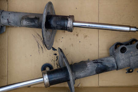 Closeup of the old shock absorbers of the city car that have been replaced after a long period of...