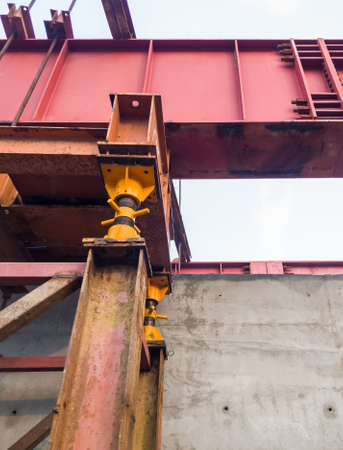 The large iron framework is installing on the top of the reinforcement concrete pole to build the...