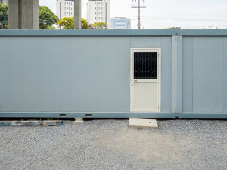 The container box  for use to the temporary office room in the construction site, near the skywalk project in the city,front view with the copy space.の写真素材