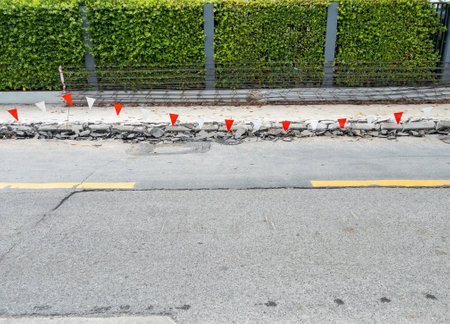 The footpath way is broken from the drilling machine for paving new footpaths near the asphalt road in the city, front view for the copy space.の写真素材