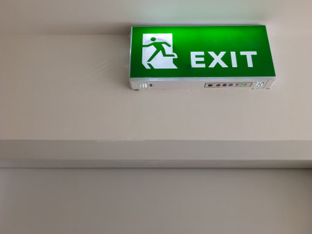 The green fire exit symbol on the ceiling shows escape routes outside the building when the fire, front view with the copy space.の写真素材