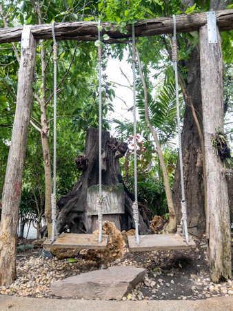 The large wooden swing with the hemp rope for playing in the garden of the countryside house, front view with the copy space.の写真素材
