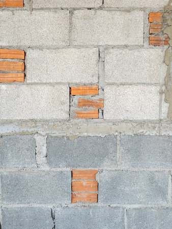 Brick block wall with the small brick of the local house in the construction, front view for the...