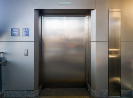 The new passenger elevator with the usage symbol for service in the suburban train train station,...