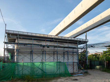 A backup power facility under construction, featuring scaffolding, netting, and elevated tracks in...