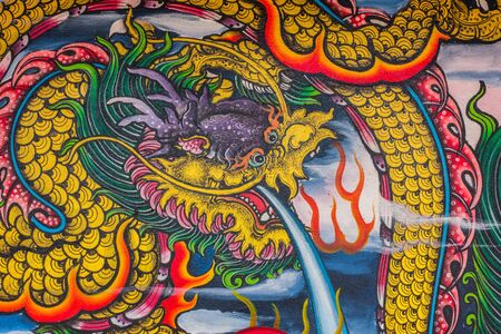 Dragon sculpure and fish one the shrines of Thailandのeditorial素材