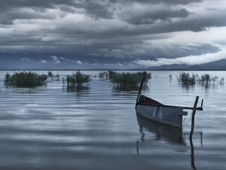 Fishing boat at dawn after the rainの写真素材