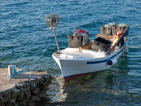 anchored fishing boat in the portの写真素材