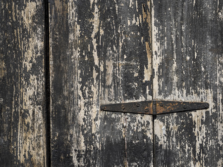 old rusty hinge on black wooden doorの写真素材