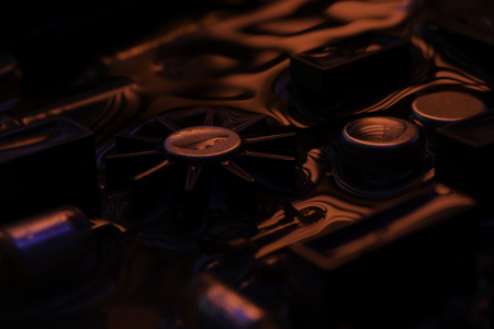 Closeup of electronic hardware. assembly on the circuit board with dark red and blue reflection, conceptual creative associationの写真素材