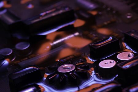 Closeup of electronic hardware. assembly on the circuit board with red and blue reflection, conceptual creative associationの写真素材