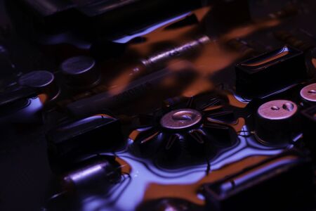 Closeup of electronic hardware. assembly on the circuit board with red and blue reflection, conceptual creative associationの写真素材