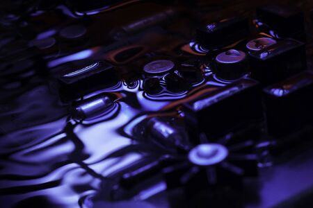 Closeup of electronic hardware. assembly on the circuit board with blue and red reflection, conceptual creative associationの写真素材
