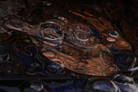 Opened Computer hard disk drive in studio with bubbles and dark red and blue reflection, conceptual creative associationの写真素材