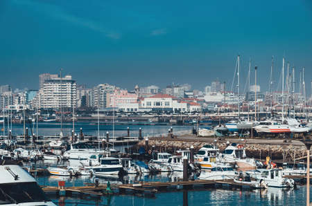 Vila do Conde, Porto / Portuhal - January 6 2019: Yachts and motor boats in the bay of Porto area. Povoa de Varzim city at the background. Daytimeのeditorial素材
