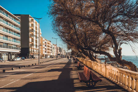 Matosinhos / Portugal - January 9 2019: A straight alleyway along the ocean in Porto area. Place for walk. Street with modern buildings and benches. Sunny dayのeditorial素材