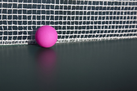 Pink table tennis table in the netの写真素材
