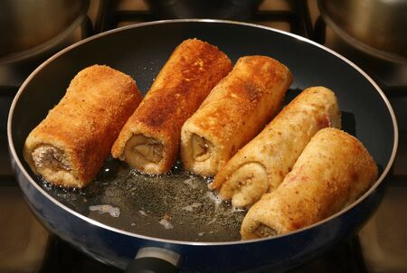 real photo golden pancakes and hot oil on panの写真素材