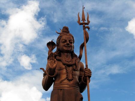 Shiva statue against the blues sky and clouds 