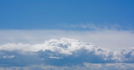Close shiny clouds on blue sky backgroundの写真素材
