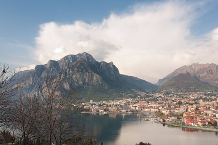 Mountains near lake with housesの写真素材