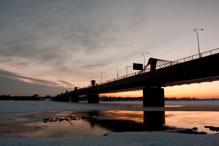 River with bridge on sunset in winterの写真素材