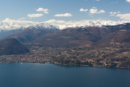 Mountains near lake with housesの写真素材
