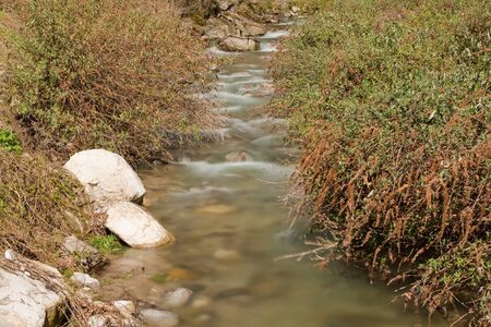 Waterfall with stones in wild nature
