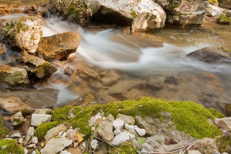 Waterfall with stones in wild nature