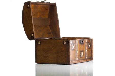 Open treasure box isolated on whiteの写真素材