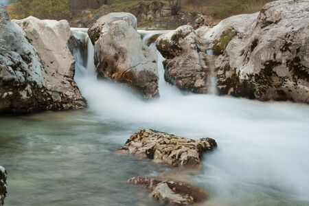 Green rive with rocks in wild natureの写真素材