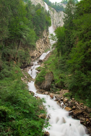 Waterfall in green nature in Switzerlandの写真素材