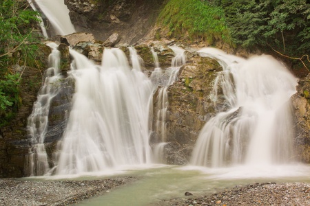 Waterfall in green nature in Switzerlandの写真素材