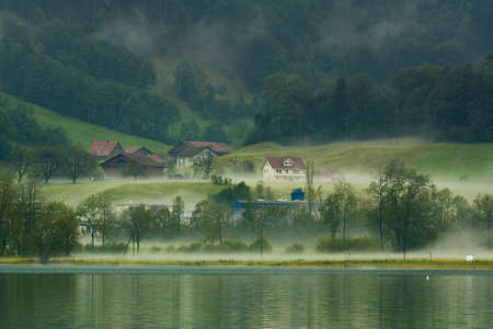Country side view in Switzerland with fogの写真素材