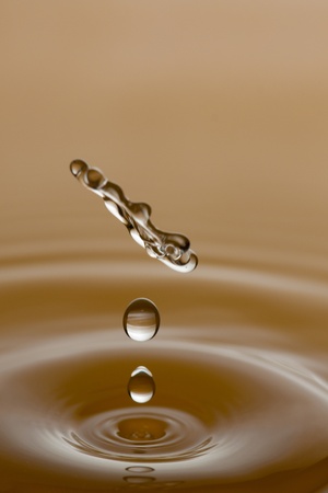 Water drop splashing macro with wavesの写真素材