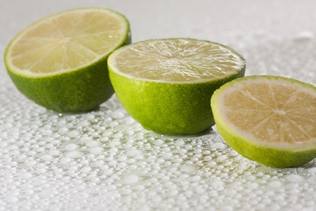 Lime with water drops on whiteの写真素材