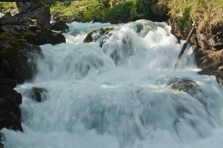 Waterfall with stones in wild nature in Austriaの写真素材