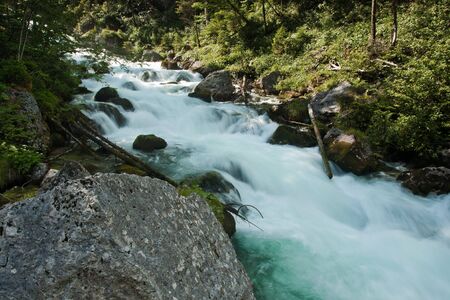 Waterfall with stones in wild nature in Austria